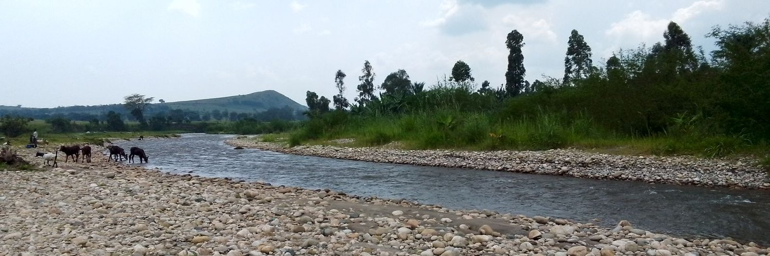 Wide river landscape with livestock at the water